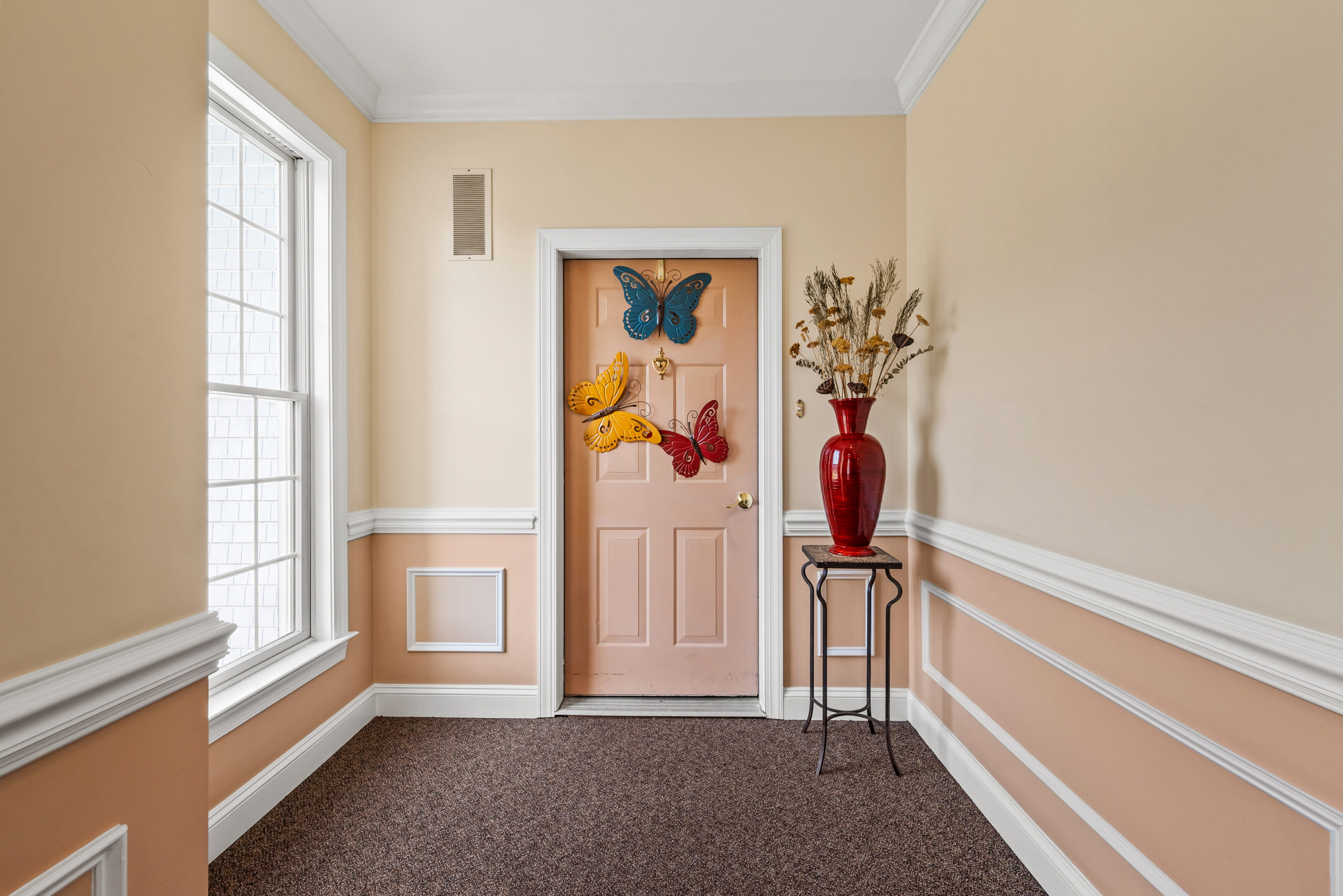 Hallway with butterfly decorations on door