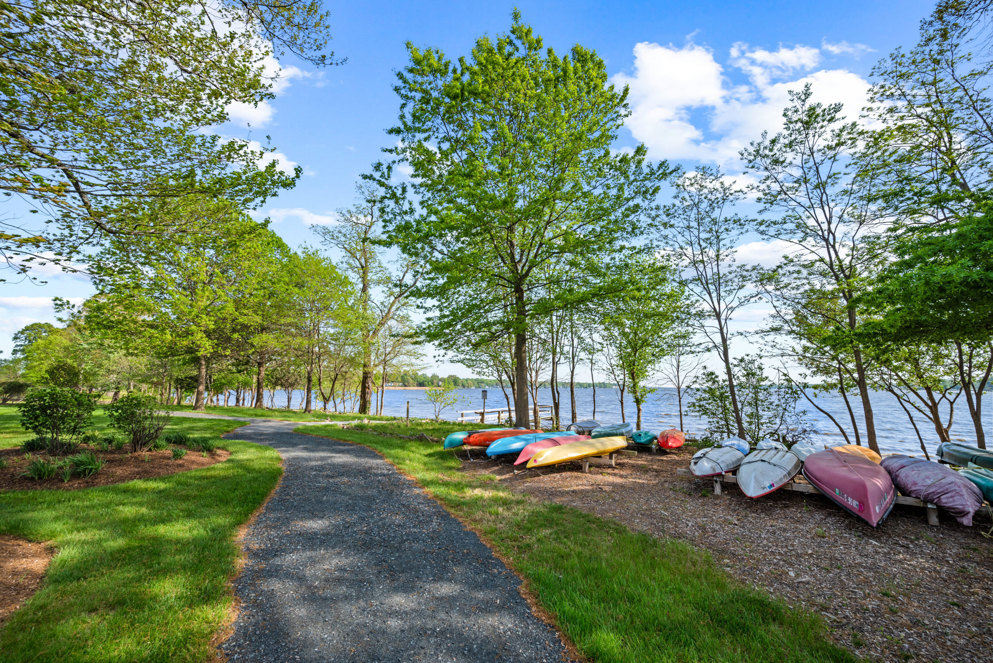 Lakeside path with colorful kayaks
