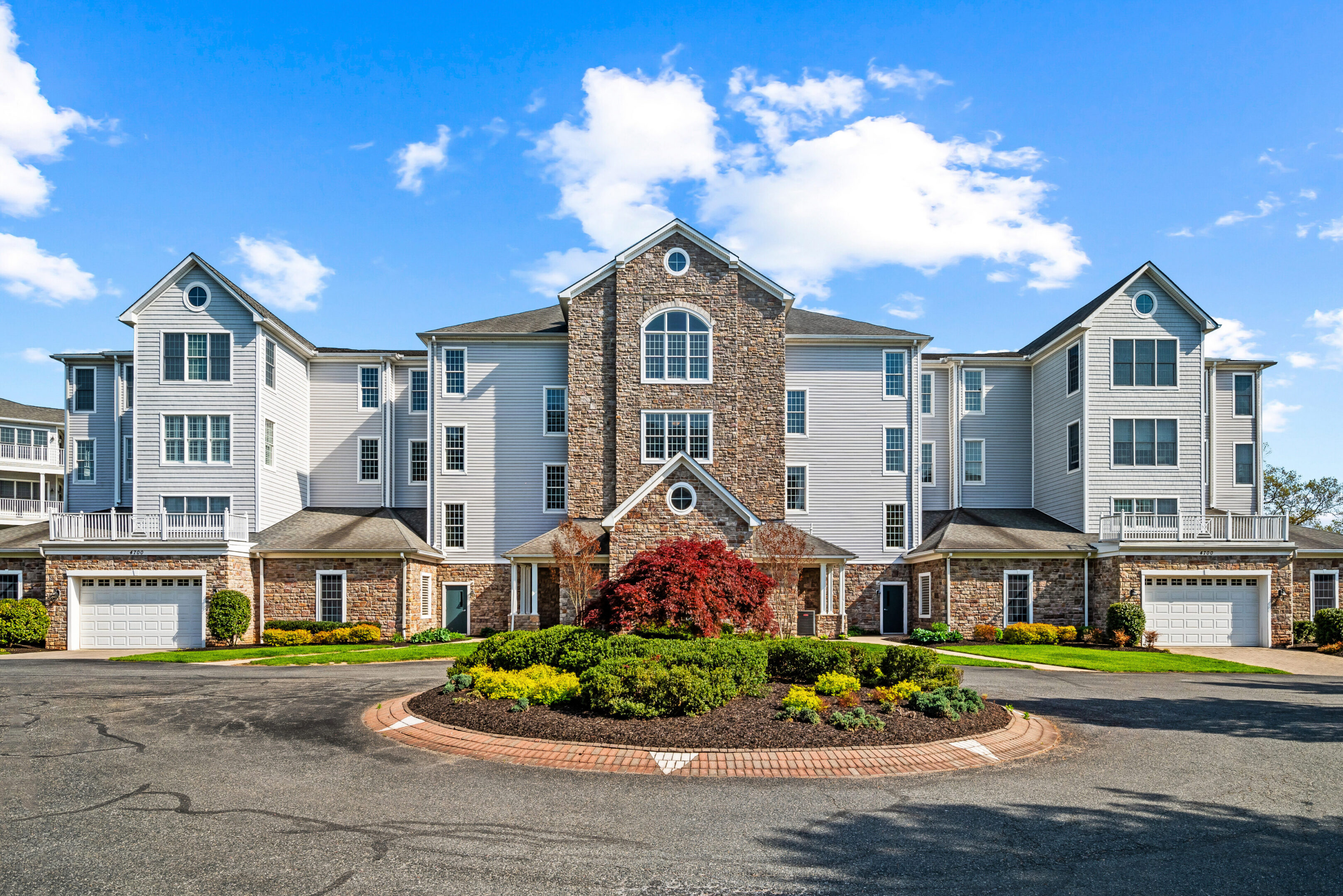 Multi-story building featuring stone and siding