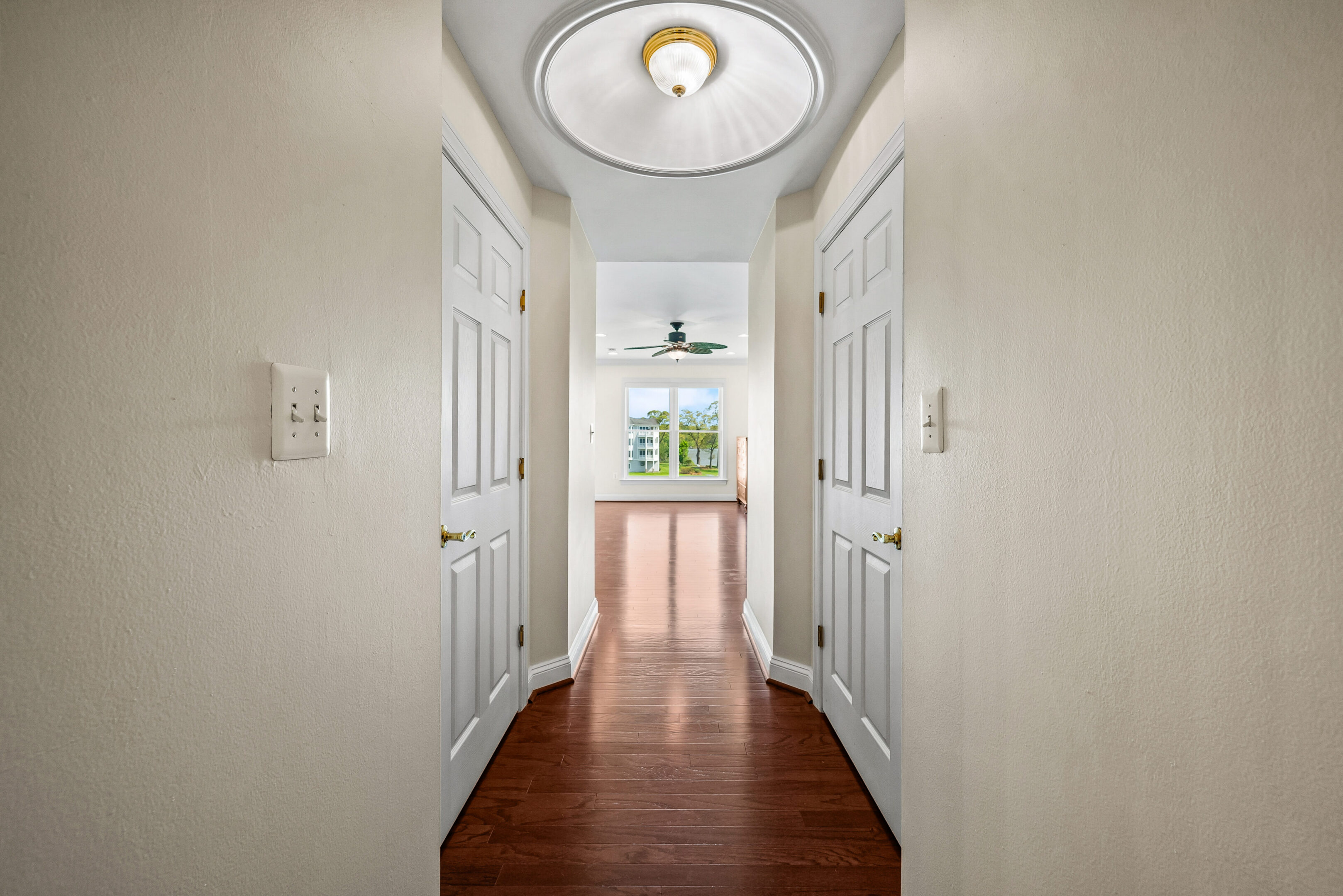 Hallway with wooden floor and ceiling light