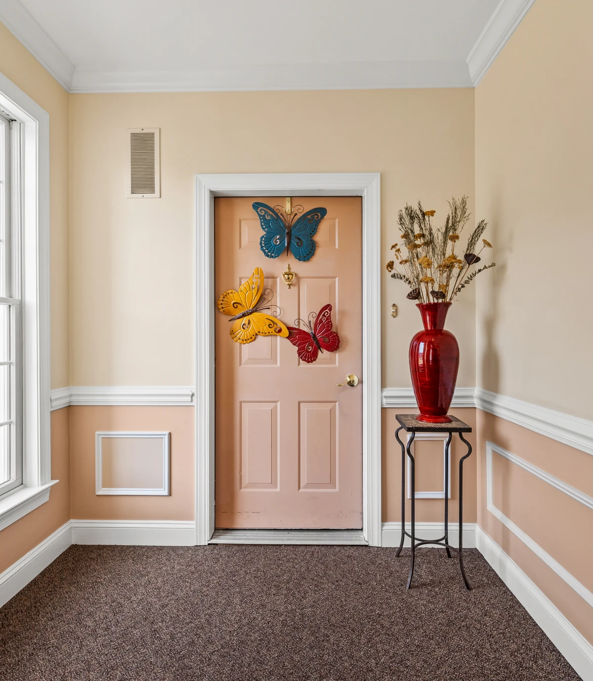 Decorative butterflies on a pink door